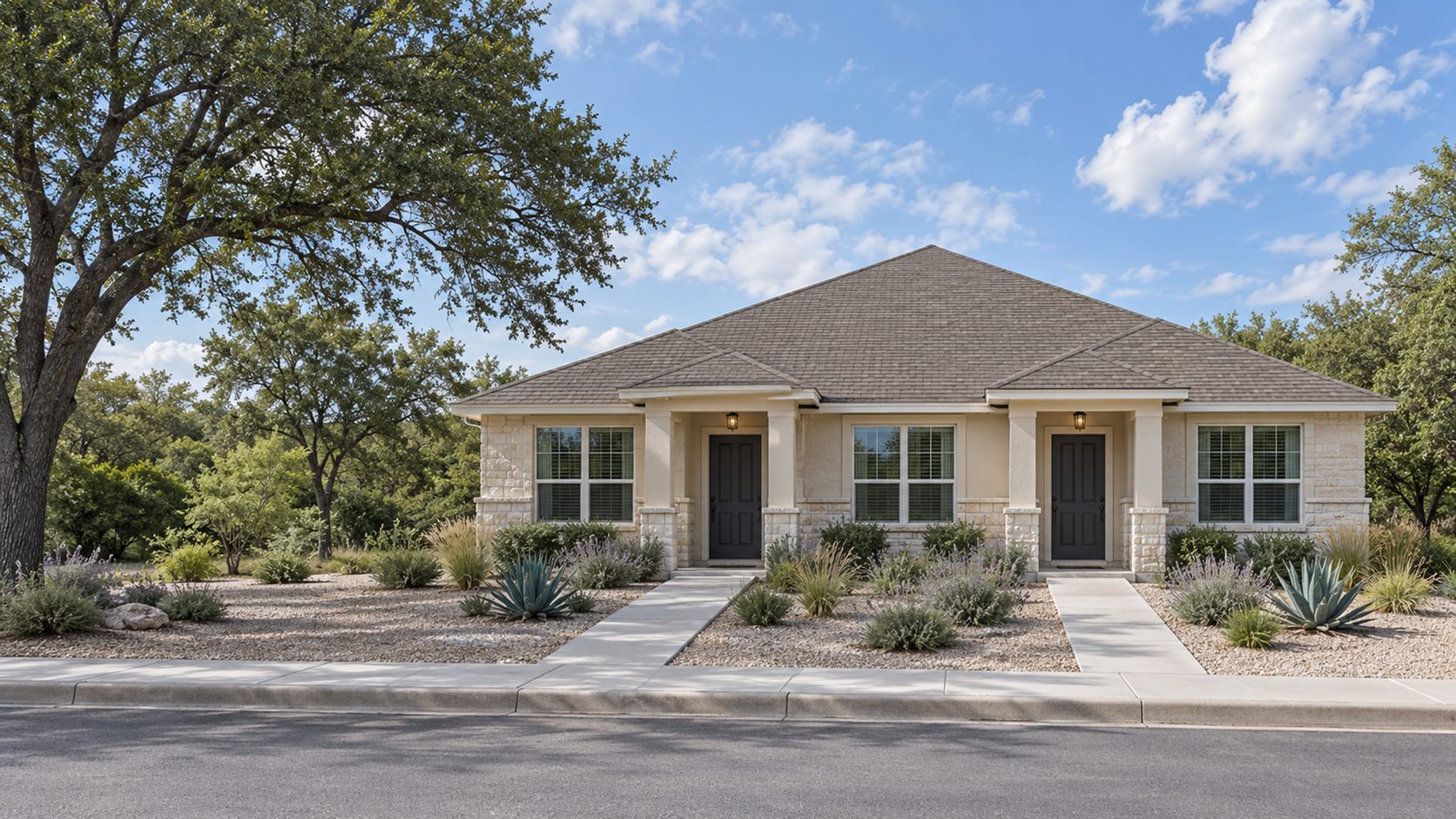 Single-story duplex with two front doors, two porches and a xeriscaped front yard